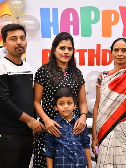 A beautiful family portrait from a birthday celebration at our center. We provide a festive backdrop with colorful decorations for your memorable family photos.