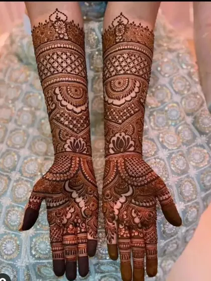 This design showcases a beautiful blend of traditional patterns, including jaali work and lotus motifs, for a classic bridal look.