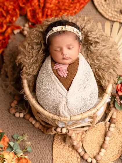 A wider view of the boho-themed newborn session, with natural fiber props and warm, earthy colors. This style creates a calm and organic feel for your baby's first portraits.