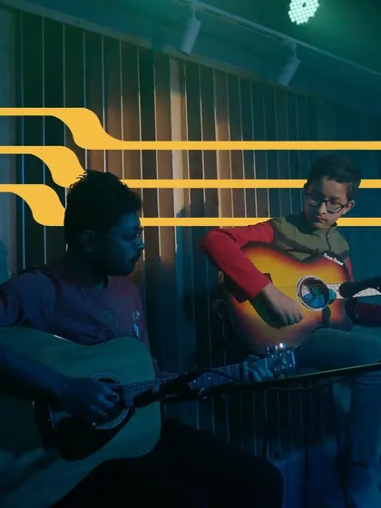 A teacher and student duo performing on acoustic guitars. This image perfectly captures the mentorship and collaborative spirit of our school.