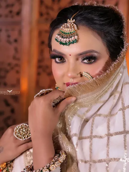 Another beautiful close-up of the bride peeking over her dupatta. This shot captures her playful personality and highlights her stunning eye makeup.