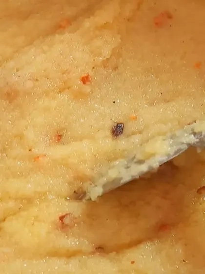 A close-up of our pineapple kesari, a sweet semolina pudding that's a favorite at celebrations. It's rich with ghee and flavored with fresh pineapple.