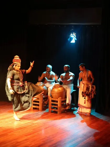 A full-stage view of the "Shaiva Koothu" performance, with the dancer and musicians.
