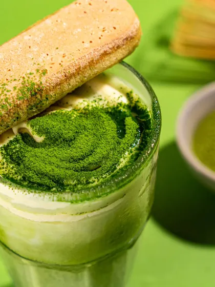 A matcha tiramisu drink from Mokai. This unique creation is styled to show both its drink and dessert qualities, with a ladyfinger biscuit as a garnish.