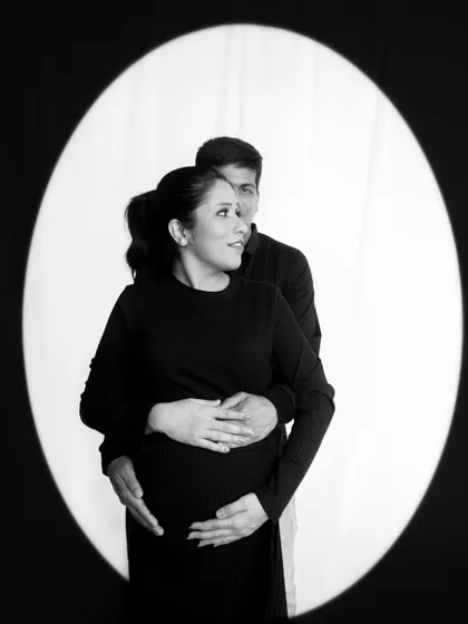 A dramatic black and white portrait using a spotlight effect. This technique creates a classic, cinematic feel for your couple's photos.
