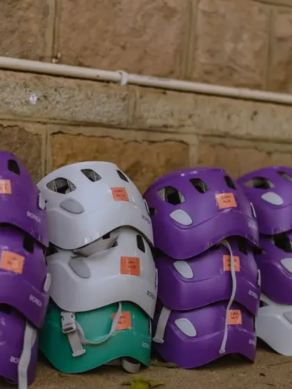 A colorful stack of helmets ready for our participants. Safety is always first, and we make sure everyone is protected.