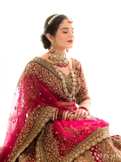 A serene and meditative portrait. The bride sits with her eyes closed, taking a quiet moment for herself before the ceremony begins.
