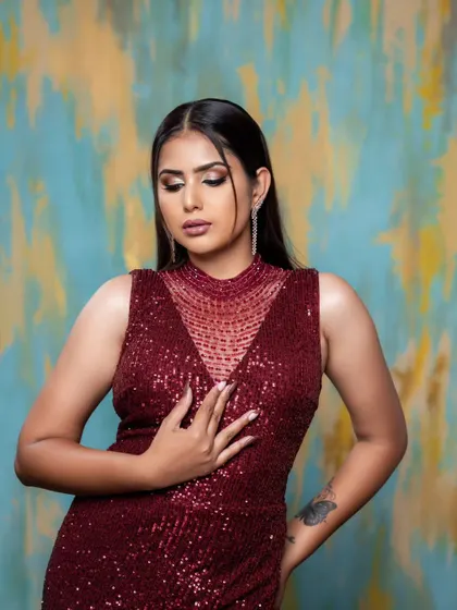 This image highlights the full effect of the maroon sequin gown, a perfect choice for a sophisticated evening.