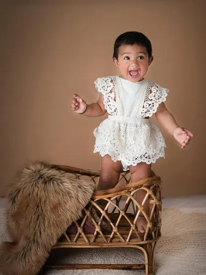 This little cutie with the big, expressive eyes has all my heart. The simple lace romper and the rustic textures of the boho setup create a beautiful, natural portrait.
