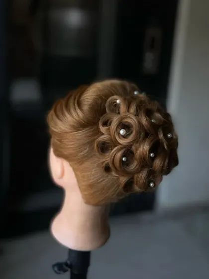 A side view of the intricate pin curl updo, showing the height and structure of the hairstyle.