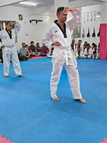 Two senior students demonstrate a high block.