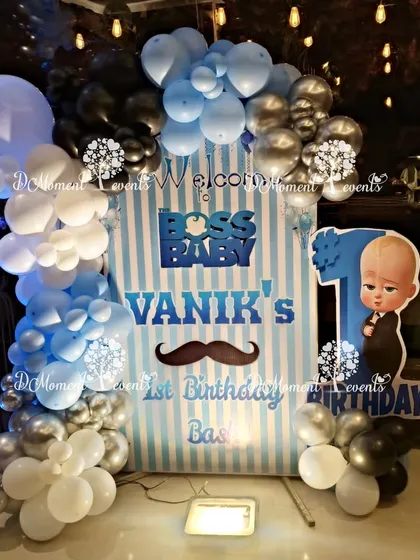 A welcome sign for "Boss Baby Vanik's 1st Birthday Bash," featuring a fun mustache detail.