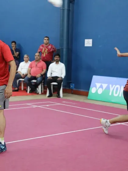 An intense moment in a doubles match, showcasing the high level of competition in the veteran and masters tournaments we manage.