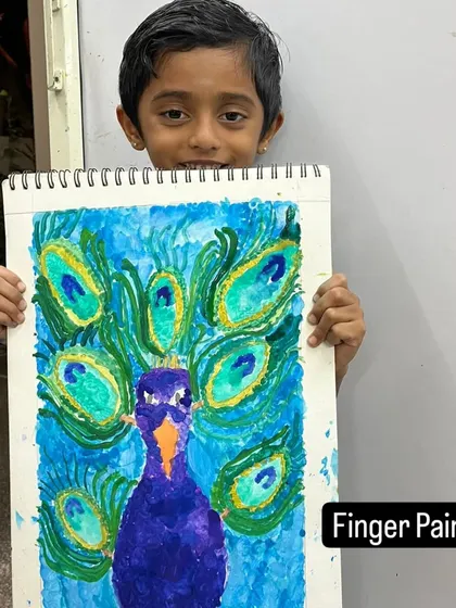 A beautiful peacock created with finger painting. This technique is a fantastic sensory experience and allows for a very direct and expressive way of applying color.