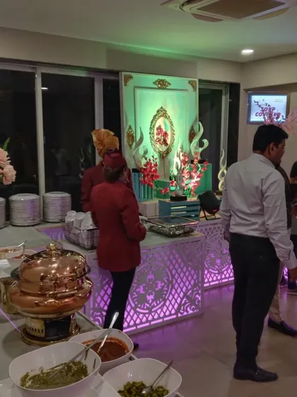 Guests enjoying the food at an indoor event. Our buffet counters are designed to be both beautiful and functional, allowing for easy movement and service.