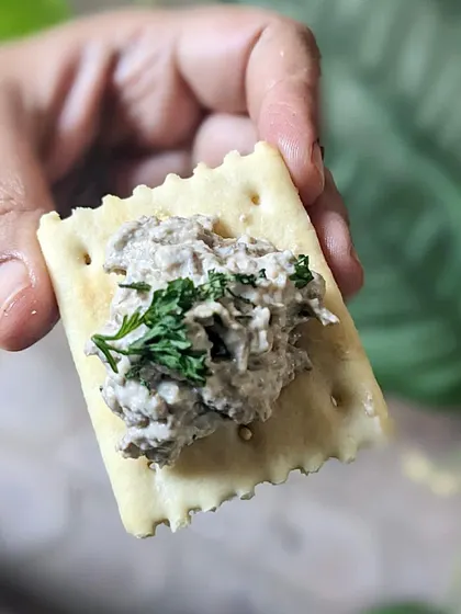 A simple, elegant serving of my roasted oyster mushroom paté on a cream cracker. It has a mellow, nutty, and creamy flavor that comes from using fresh, locally sourced mushrooms.
