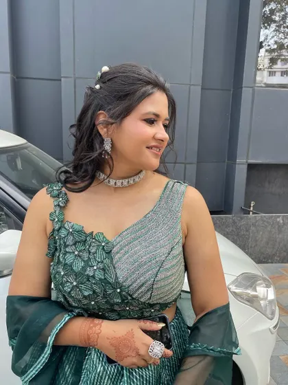 A side profile, showing the messy ponytail with pearl accessories and the soft, glowing makeup.