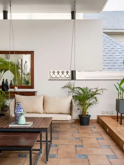 An alternate view of the outdoor lounge, showcasing the blend of natural wood decking, comfortable seating, and curated planters. This space is designed for relaxation and enjoying the pleasant Bangalore weather.