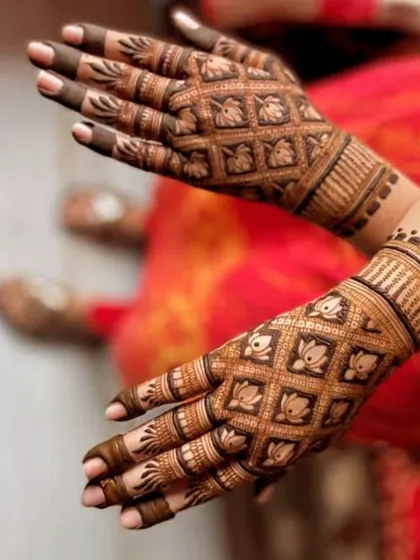 This elegant design features a repeating grid pattern on the back of the hands, with a delicate lotus motif inside each square. The fingertips are shaded dark to make the design pop.