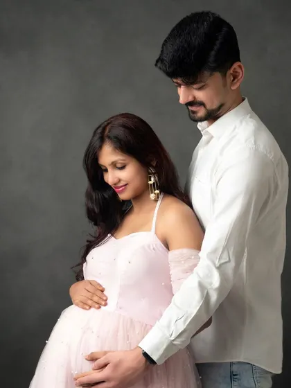 A moment of quiet connection. The soft lighting and their gentle embrace make this a truly romantic and timeless maternity portrait.