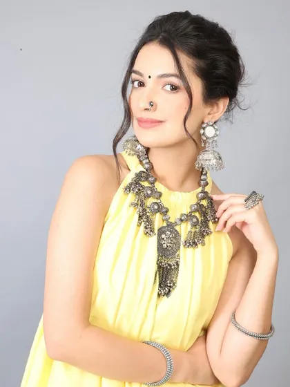 A fresh and radiant look for an ethnic wear brand. I focused on creating a dewy skin finish, soft smokey eyes, and a subtle pink lip to complement the bright yellow outfit and oxidized silver jewelry, perfect for daytime events and commercial photography.