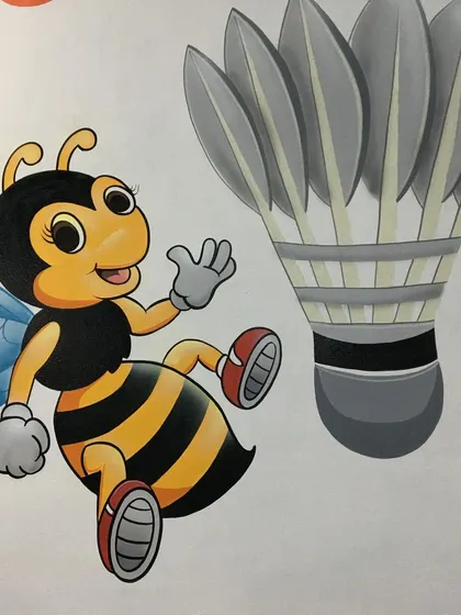 A close-up of the hand-painted bee mascot and shuttlecock from the Twin Bee Sports Arena mural. Our cartoon and illustrative style is perfect for creating friendly and engaging characters.
