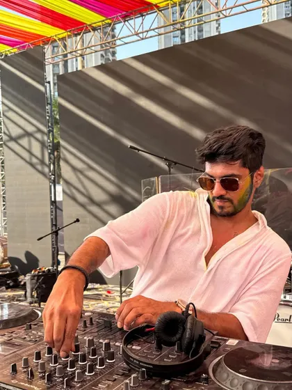 In the zone during the Holi set. Mixing tracks under the colorful banners, I'm focused on delivering the perfect soundtrack for the festival of colors.