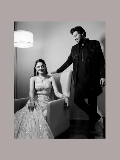 A sweet moment between the couple at their sangeet, he looking down at her with affection as she smiles.