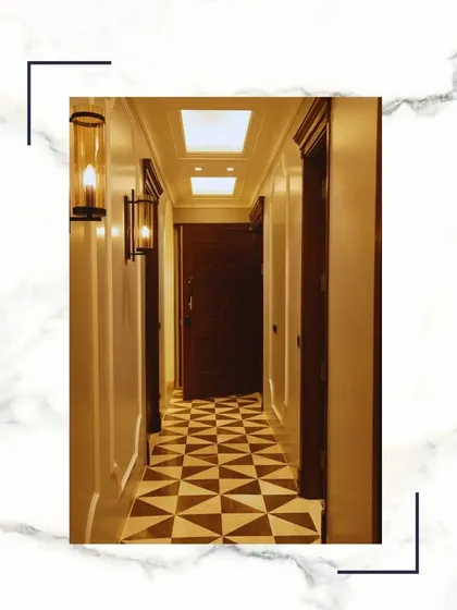 Embrace unparalleled luxury in our hallways. The combination of geometric marble flooring, classic wall sconces, and high ceilings whispers opulence and refinement.