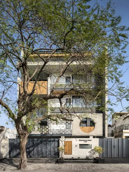 For the Swatantra Residence, I integrated the existing tree into the design as a natural privacy screen and shading element. The tree softens the bold concrete façade and creates a beautiful interplay of nature and architecture.