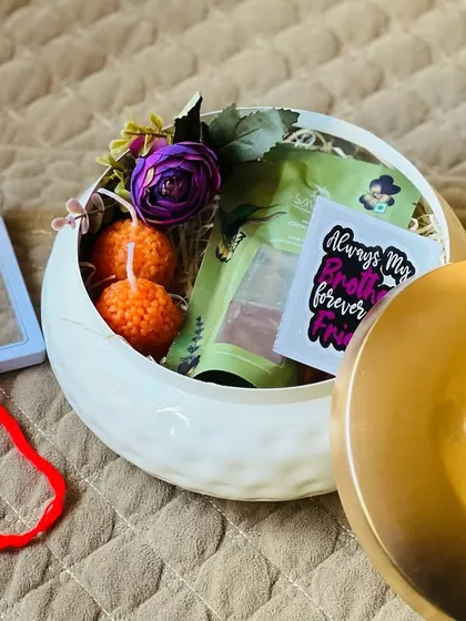 Another view of the ceramic pot Rakhi gift, showing the beautiful arrangement of items inside.