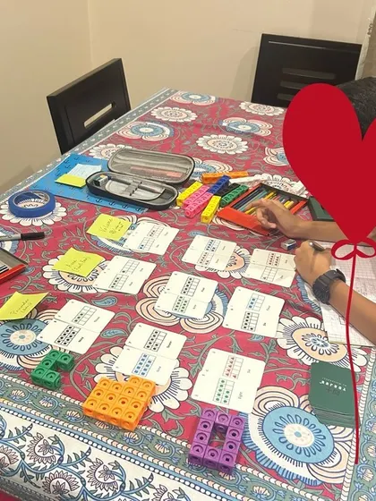 A complete STREAM (Science, Technology, Reading, Engineering, Art, and Mathematics) setup at home. This image shows how different subjects can be integrated through hands-on projects using tools like Yonjuu cards and connecting cubes.