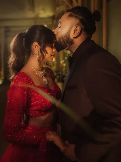 A tender forehead kiss is a simple gesture filled with so much love and protection. I captured this intimate moment during their reception, with soft lighting enhancing the romantic mood.