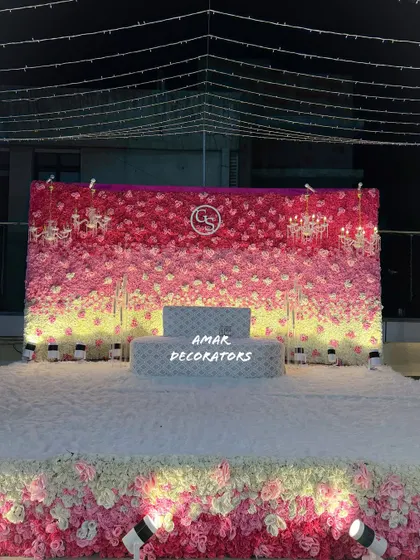 A slightly different angle of the rooftop floral stage, showing the custom monogram and chandelier details on the backdrop. It’s these personal touches that make your event decor unique.