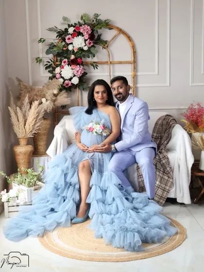 A classic seated portrait of the couple in the boho corner. They look so happy and connected as they await their baby.