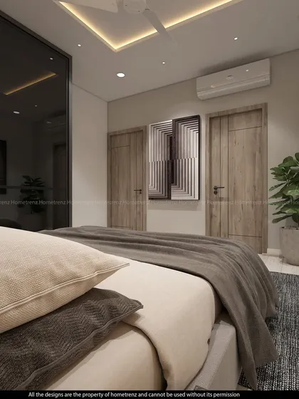 A guest bedroom with dark wood doors and a large wardrobe with smoked glass sliding doors.