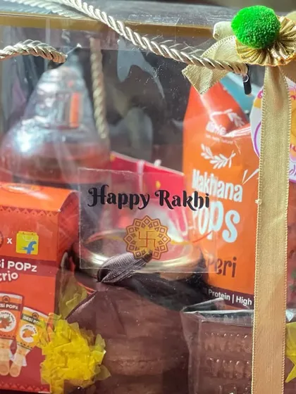 A Rakhi gift bag filled with desi treats like Desi Popz and makhana, perfect for a traditional taste.