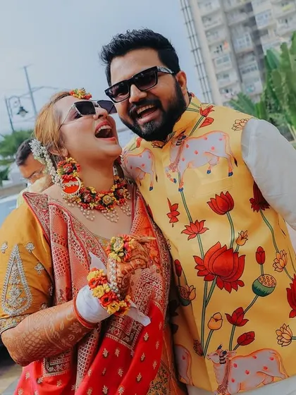 For me, the best shots are the unscripted ones. This candid photo from a Haldi ceremony captures a moment of pure, uninhibited laughter between the couple, showing the real fun and 'hasi-masti' of a wedding.