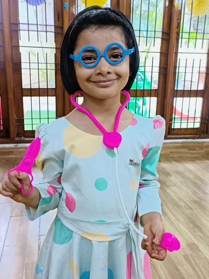 A happy student dressed as a doctor for Doctor's Day.
