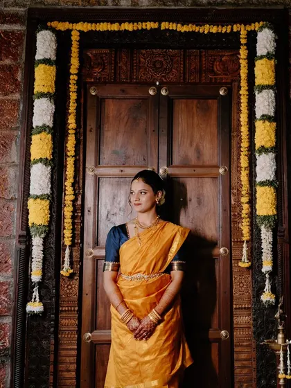 Dhanya's engagement look in a traditional nine-yard saree, perfect for an Iyengar ceremony.