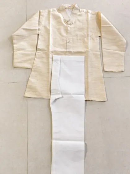 This simple and elegant cream kurta with white pants is a versatile outfit. It can be used to dress up your child as Jawaharlal Nehru or other political leaders for school competitions.