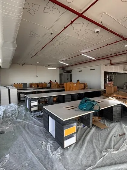 The open-plan workspace at the Carlsberg office during the furniture installation phase. Desks are being assembled and arranged according to our layout, which is designed to blend productivity with leisure.