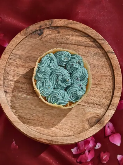 A royal twist on tradition. My blueberry-flavoured ghewar is vibrant, velvety, and oh-so-delicious. A unique treat for Teej.