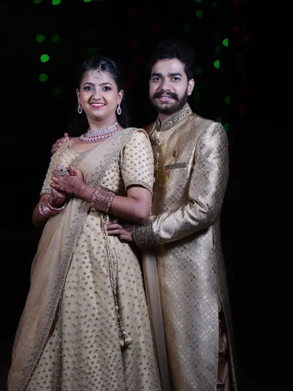 The happy couple at their reception. The bride's makeup is elegant and timeless, designed to look beautiful both in person and in photographs.