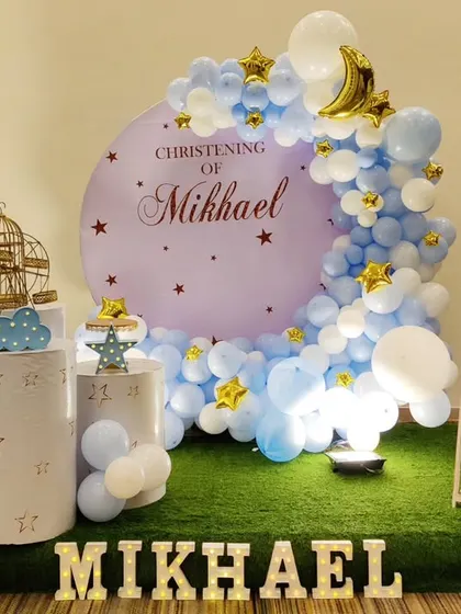 A serene and beautiful Christening setup for Mikhael. The decor features a "Twinkle Twinkle Little Star" theme with a blue and white color palette, a crescent moon backdrop, and star accents.