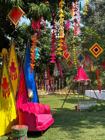 A closer look at the seating area for the Mehandi. The bright pink sofa and colorful decor elements create a perfect photo opportunity and a comfortable spot for the bride.