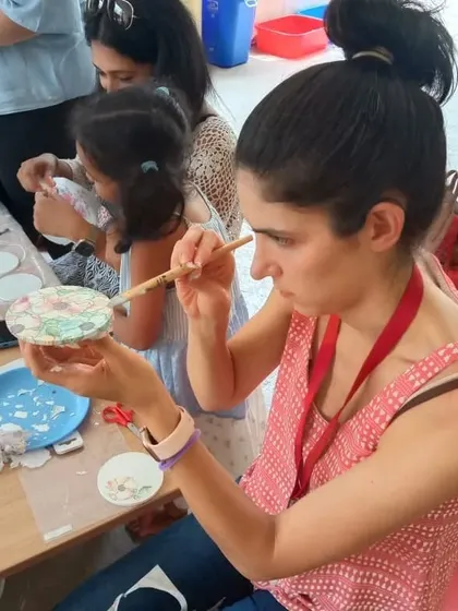 A participant working on a decoupage coaster during our special Mother's Day workshop.