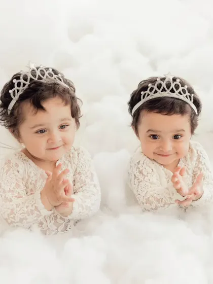 Two little princesses in a bed of clouds. We have experience with twin photoshoots, creating magical and coordinated portraits that celebrate their special bond.