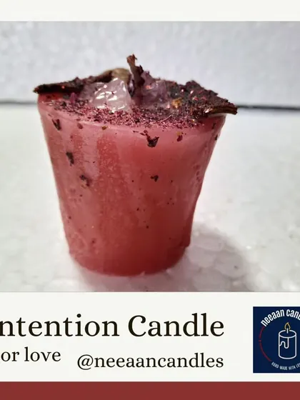 This is my Love Intention candle, infused with herbs and crystals like rose quartz to help you attract loving energy. Light it to nurture self-love or call in a positive relationship.