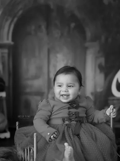 A timeless black and white portrait of the birthday girl. Even without color, her joyful expression and the beautiful setup shine through.